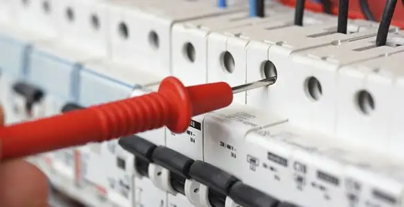 Electrical contractor testing circuit breakers during electrical repair in Ceres, CA