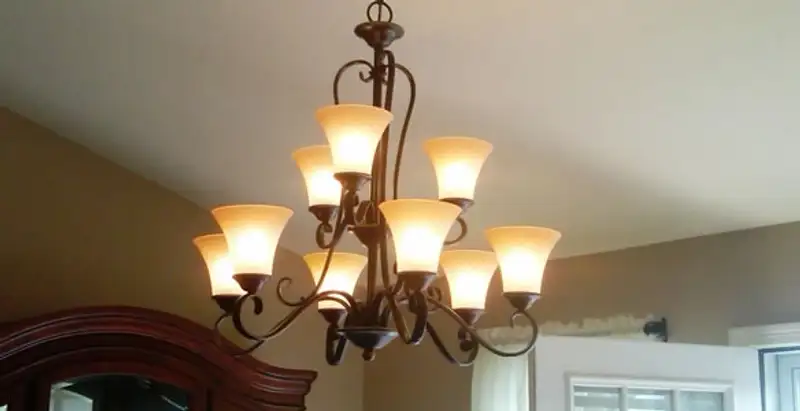 Classic ceiling chandelier installation with warm lighting in Modesto, CA