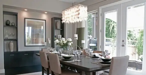 Elegant dining room chandelier installation above table in Modesto, CA
