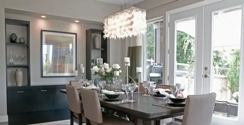 Elegant dining room chandelier installation above table in Modesto, CA