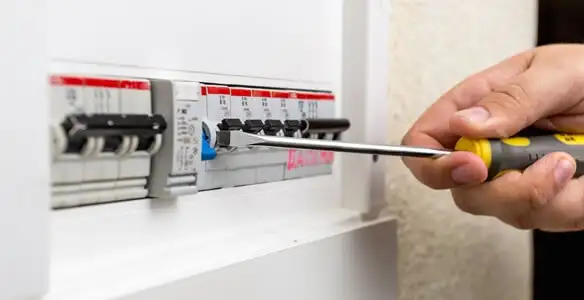 electrical panel upgrade service showing technician adjusting circuit breakers during system upgrade in Modesto, CA