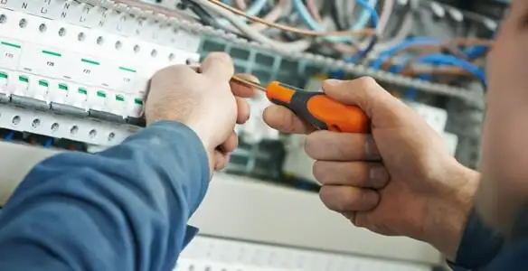 electrical service showing licensed electrician performing electrical panel maintenance and adjustments in Modesto, CA