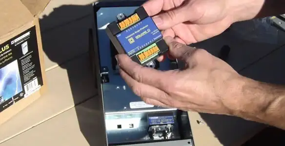 Electrician installing whole home surge protection unit inside main electrical panel in Modesto, CA