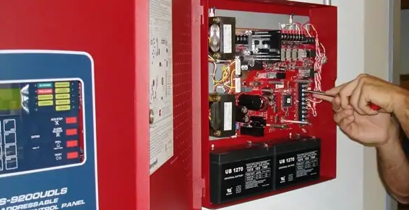 fire alarm installation service showing technician configuring fire alarm control panel in Modesto, CA