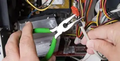Licensed electrical contractor performing electrical repair with tools in Ceres, CA