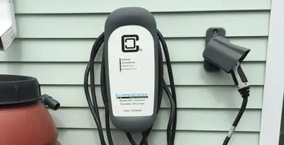 Outdoor electric vehicle charger installation on residential wall in Modesto, CA